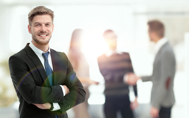 Portrait of an handsome businessman in front of his team